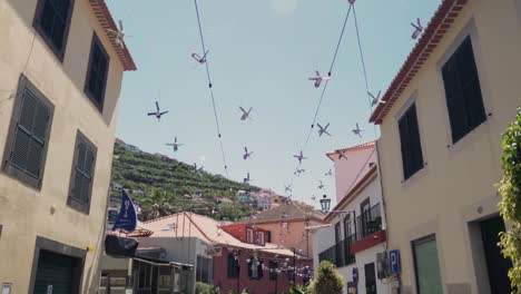 decorative propeller decorations in a narrow town street