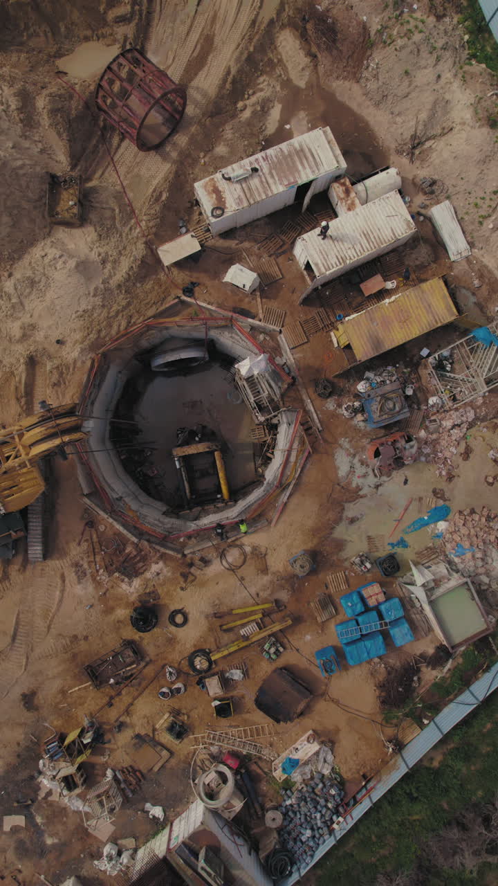 Coastal residential construction excavator heavy machinery working vertical video Mediterranean seaside development housing project infrastructure building