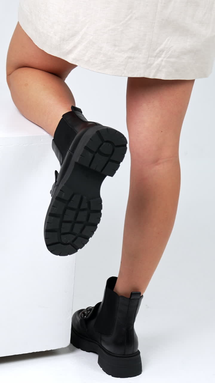 Woman trying footwear in shoe store. New style shoes showroom. Vertical video