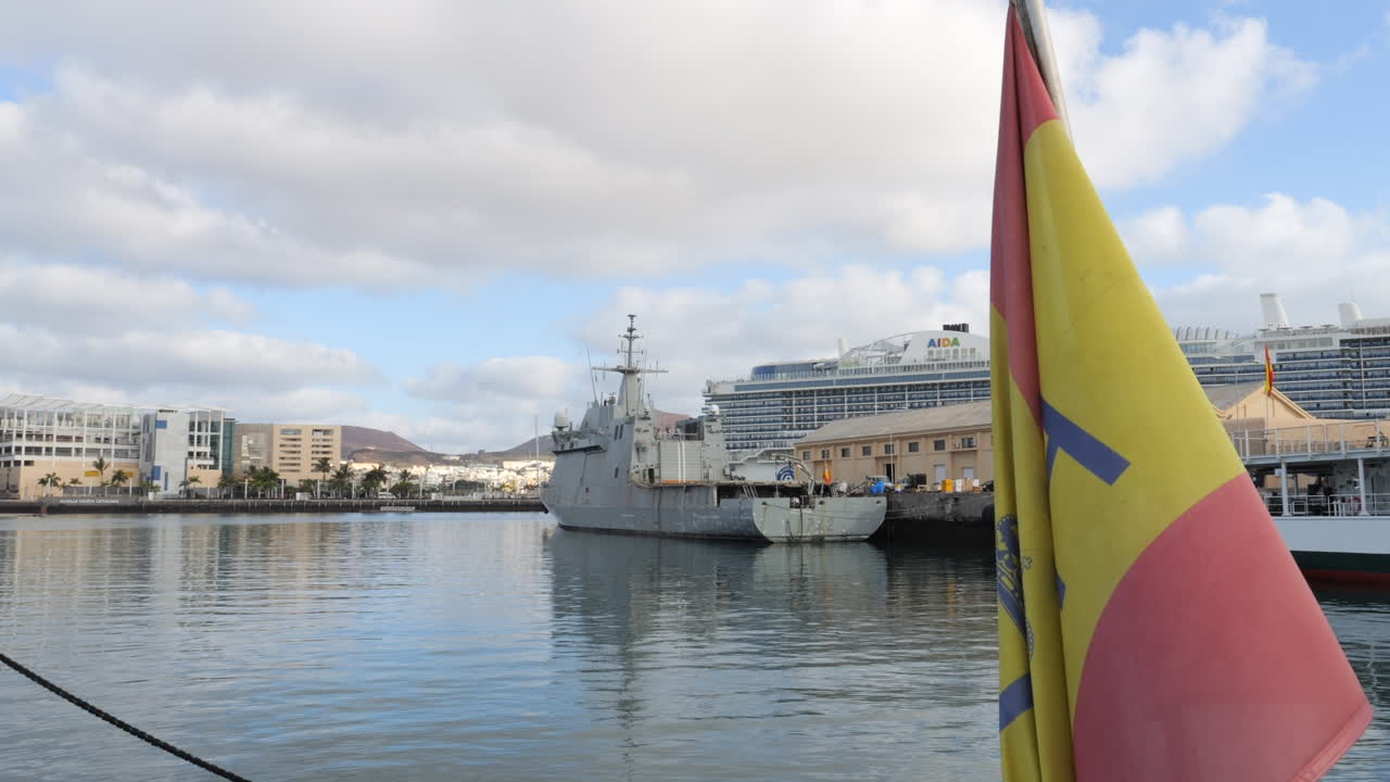 Customs police patrol ship remains anchored at Gran Canaria port. The scene includes surrounding buildings and maritime elements