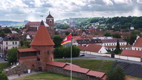 kaunas castle tower and downtown rooftops, aerial orbit view