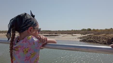 Caucasian-Young-Girl-Riding-A-Ferry-Boat-Sailing-Over-Gilao-River-In-Tavira,-Southern-Portugal