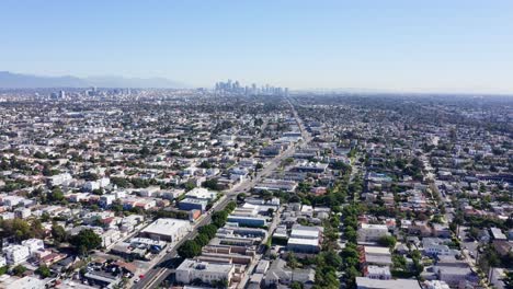 drone shot of los angeles ca usa, flying above mid city neighborhood on hot sunny day