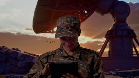 close up of asian man soldier using a tablet while standing with satellite dish