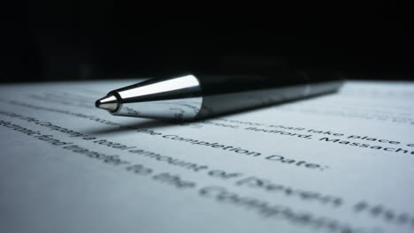 Closeup-black-pen-lying-on-paper-contract.-Macro-shot-stamp-with-text-top-secret