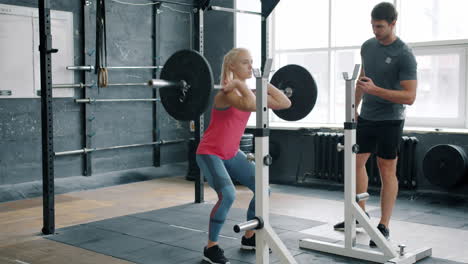 woman weightlifting with personal trainer