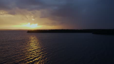 aerial view of a beautiful lake at sunset under a tempestuous sky