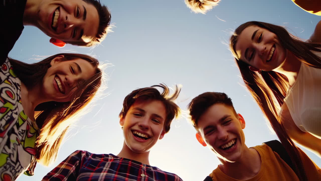 Group of Young Friends Smiling and Looking Down at the Camera