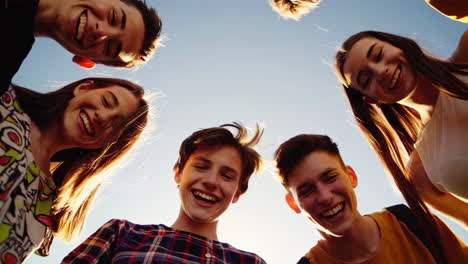 group of young friends smiling and looking down at the camera