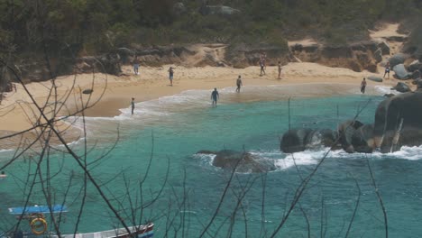 Slow-motion-revealing-shot-of-the-shore-at-the-beach-in-Tayrona-Park,-Colombia