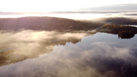 Morning-fog-with-sun-rays-between-mountains-and-lakes-in-La-Verendrye-Wildlife-Reserve