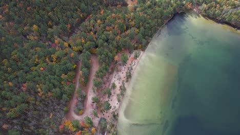 birds eye aerial view of white lake, new hampshire usa, lakefront and forest of state park at fall season, drone shot