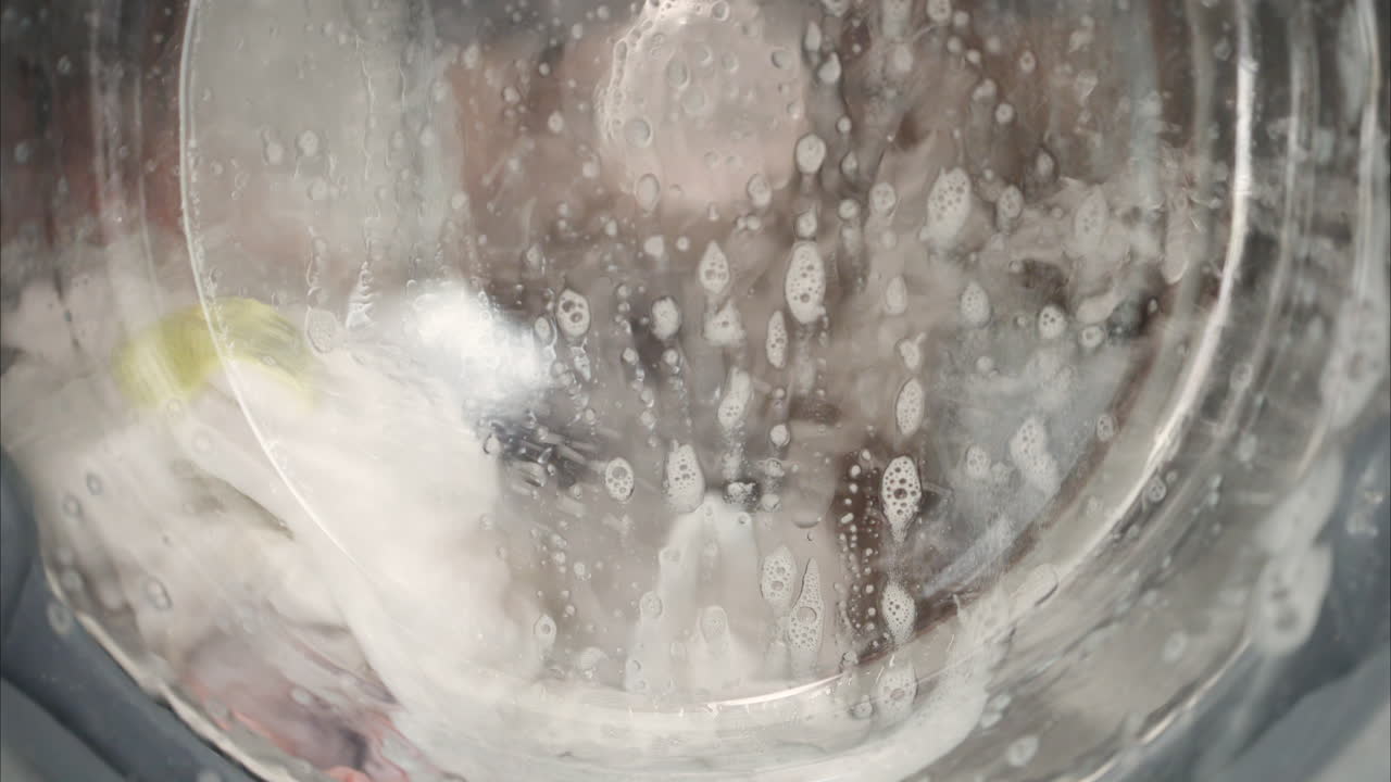 Close up of clothing being laundered in the washing machine