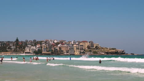Zoom out of People enjoying the water at Bondi Beach