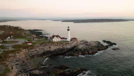 stunning oscillating aerial shot of the portland headlight lighthouse in portland, maine