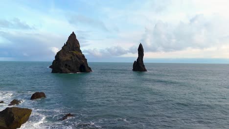 Aerial-view-of-beautiful-scenic-ocean-landscape-with-huge-rock-formations-in-Iceland