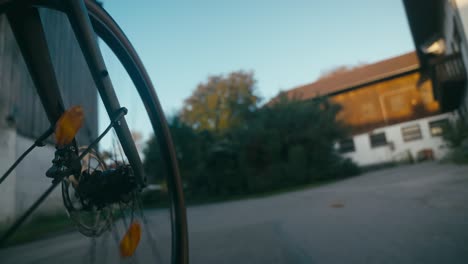 bicycle wheel pov with blurred background of a suburban area at dusk