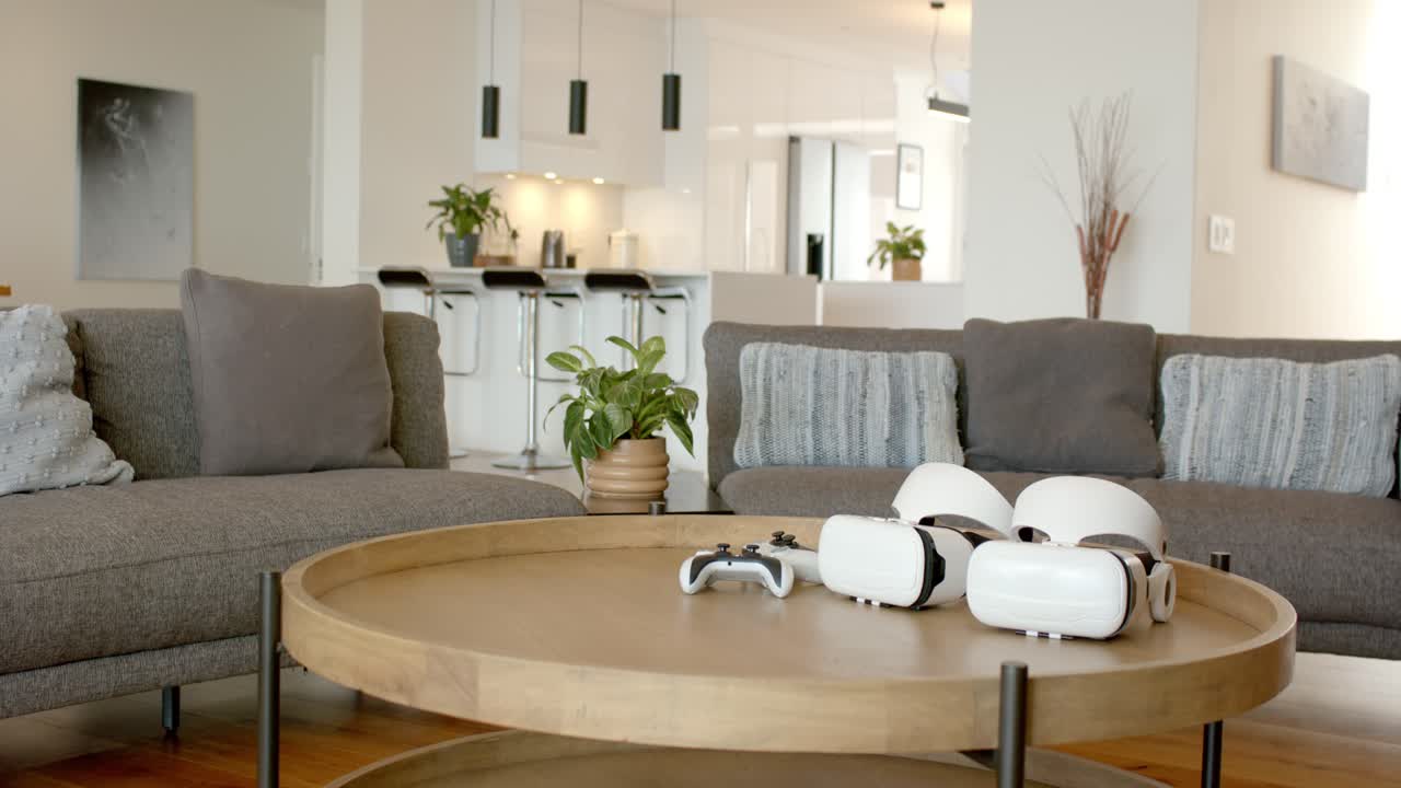 coffee table is featuring two VR headsets and game controller while sitting in home for gaming