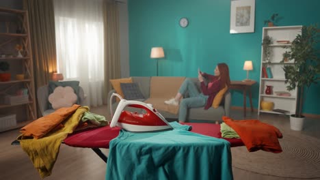 woman ironing clothes in a living room