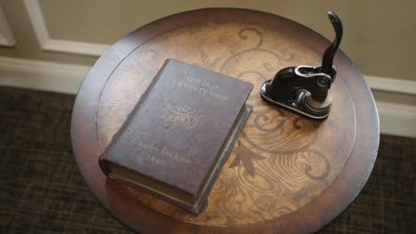 Slow-pan-turning-shot-of-novel-and-antique-seal-sitting-on-an-end-table