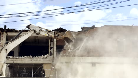 excavator demolishes wardamaged building in ukraine to prepare area for postwar reconstruction work