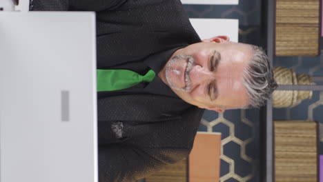 vertical video of happy businessman getting good results on laptop.