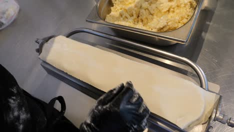 el chef prepara la masa y llena el molde para crear albóndigas