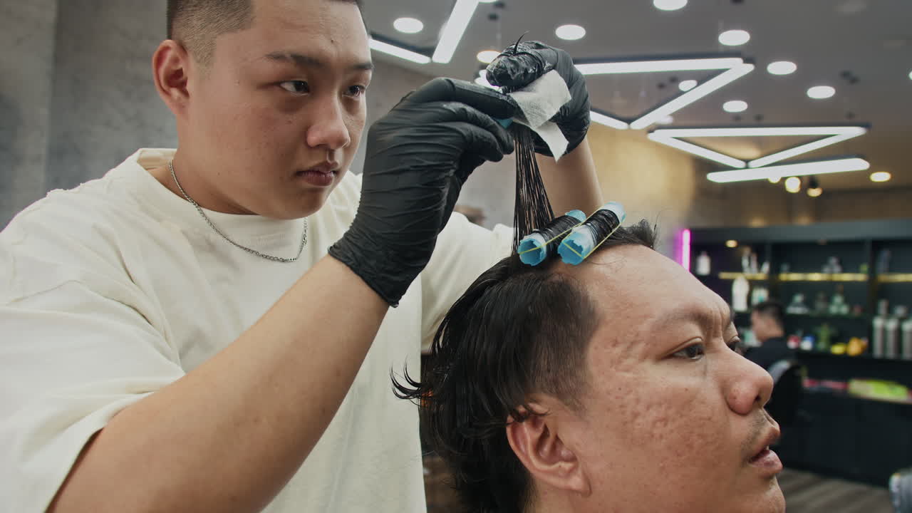 Hairdresser styling a man's hair