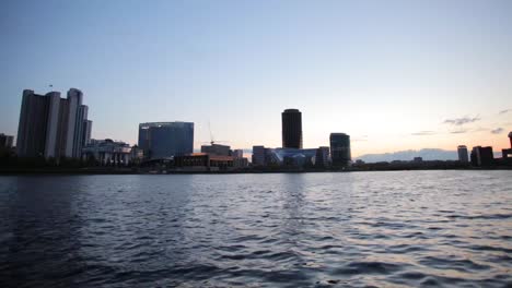 city skyline at sunset over river