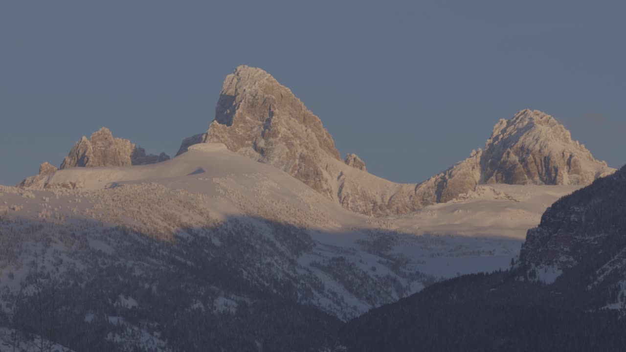 High mountain peaks bathed in sunset light in far western Wyoming