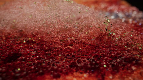 macro photography of red and pink glitter bubbles