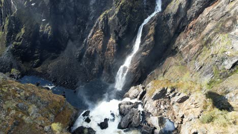 Aerial-Dolly-Forward-To-Reveal-Overhead-View-Of-Cascading-Voringsfossen-Waterfall-In-Norway