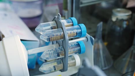 test tubes spinning in a rotator during a science experiment in a lab