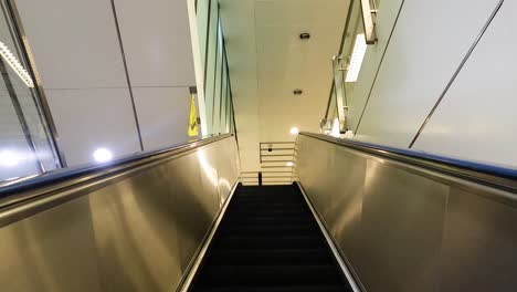 ascending escalator in a bangkok subway station