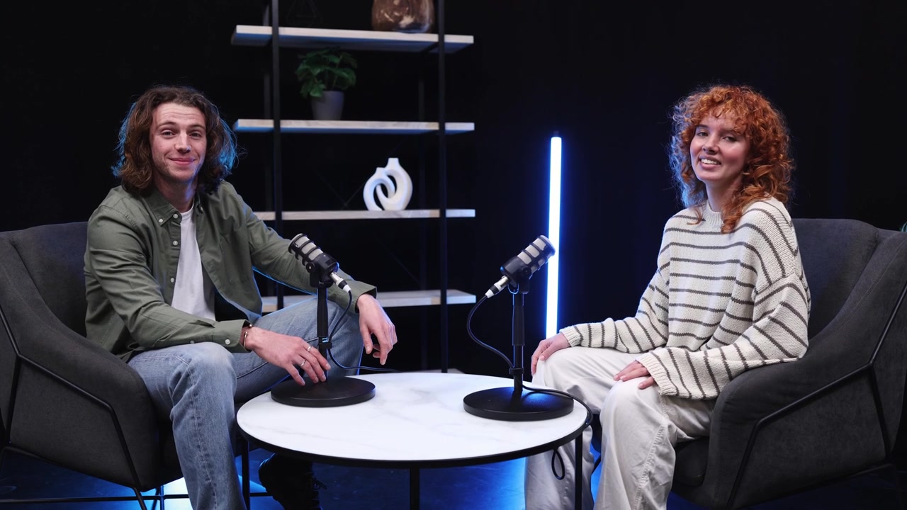 Young Man and Woman Recording a Podcast in a Modern Studio