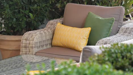 outdoor wicker patio set with cushions and plants