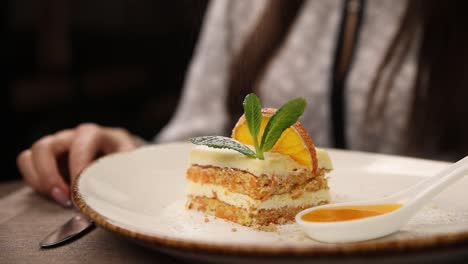 woman enjoying a slice of carrot cake