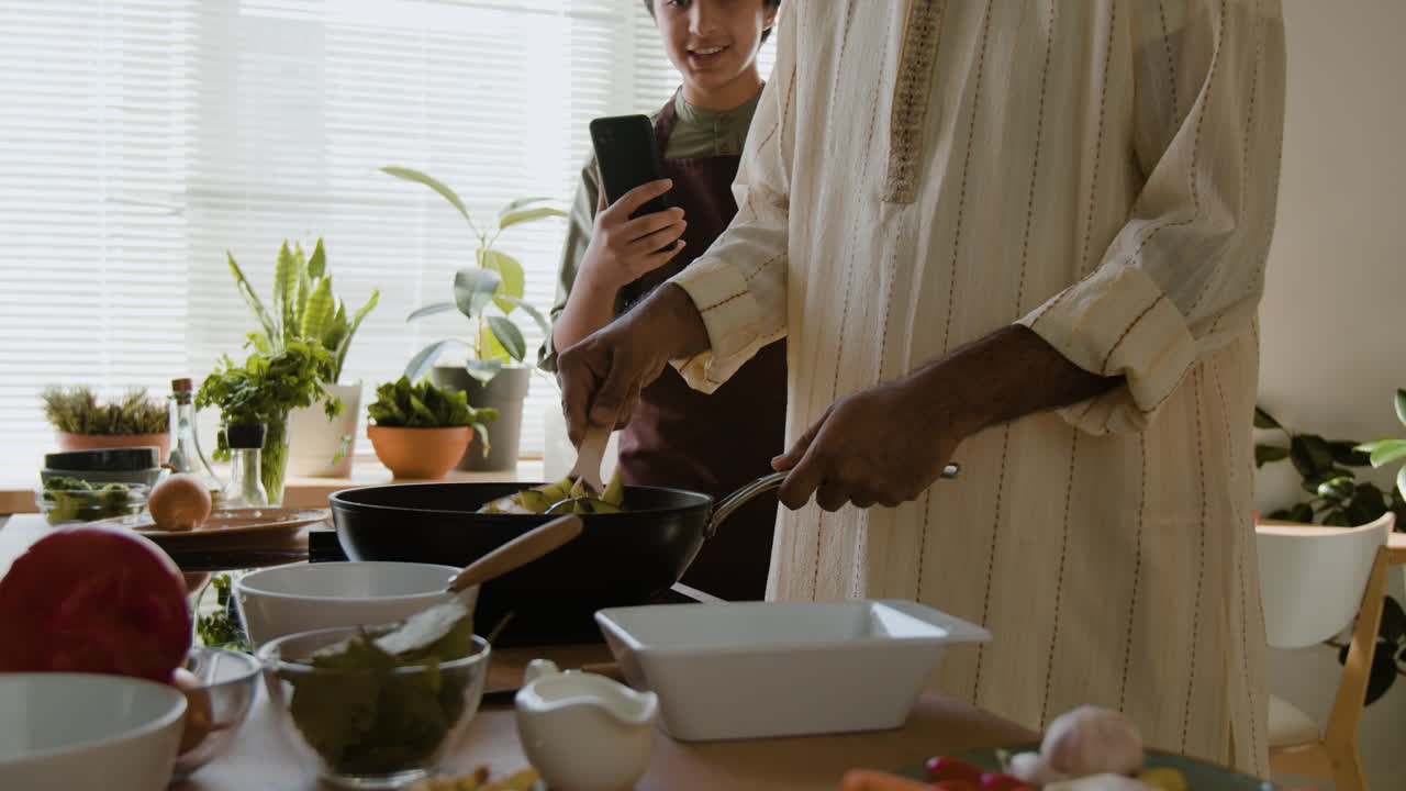 Father and Son Cooking Together in the Kitchen