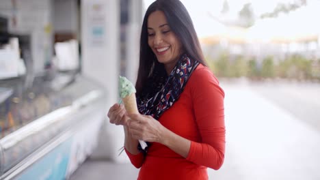 Attractive-young-woman-eating-an-ice-cream-cone