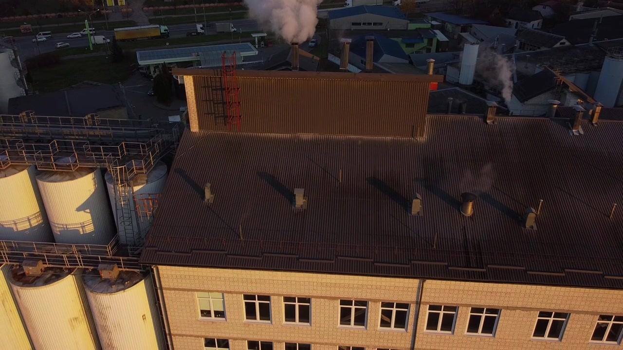 Aerial view of a drone flying over the beer production plant, several rows of tanks.
