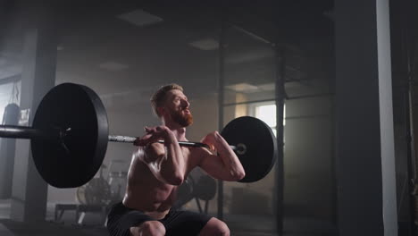 Slow-motion-of-crossfit-athlete-performs-clean-and-jerk.-Young-man-doing-the-clean-and-jerk-weightlifting-exercise-at-the-gym.