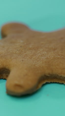 the confectionery nozzle is drawing the image of a person on the finished ginger biscuits with icing. close-up. christmas cookies vertical video