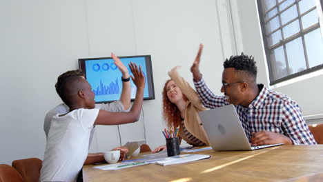 Side-view-of-young-mixed-race-business-team-working-in-meeting-room-of-modern-office-4k