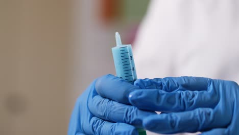 a small amount of a liquid is pushed out of a syringe