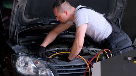 a mechanic working on a car engine in a workshop