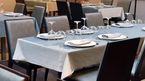 restaurant dining room with well-dressed tables with leather chairs