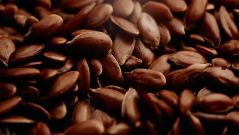 macro shot of heap of linseed or roasted flaxseed grain