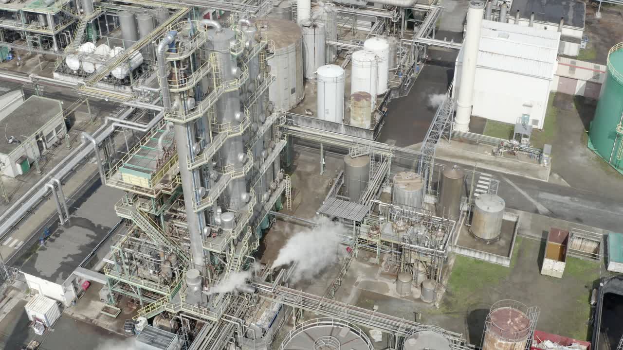 Aerial circling industrial processing unit with steam, tanks, pipes, Veille-Saint-Girons, France. Chemical plant operation