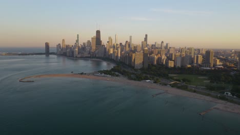 drone flying away from downtown chicago on typical summer day in the cityq