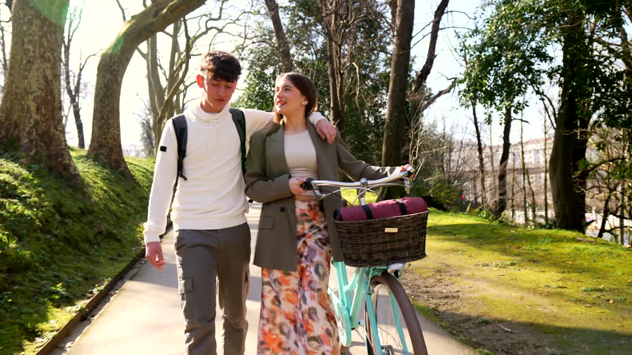 Couple Enjoying a Walk in the Park with a Bicycle